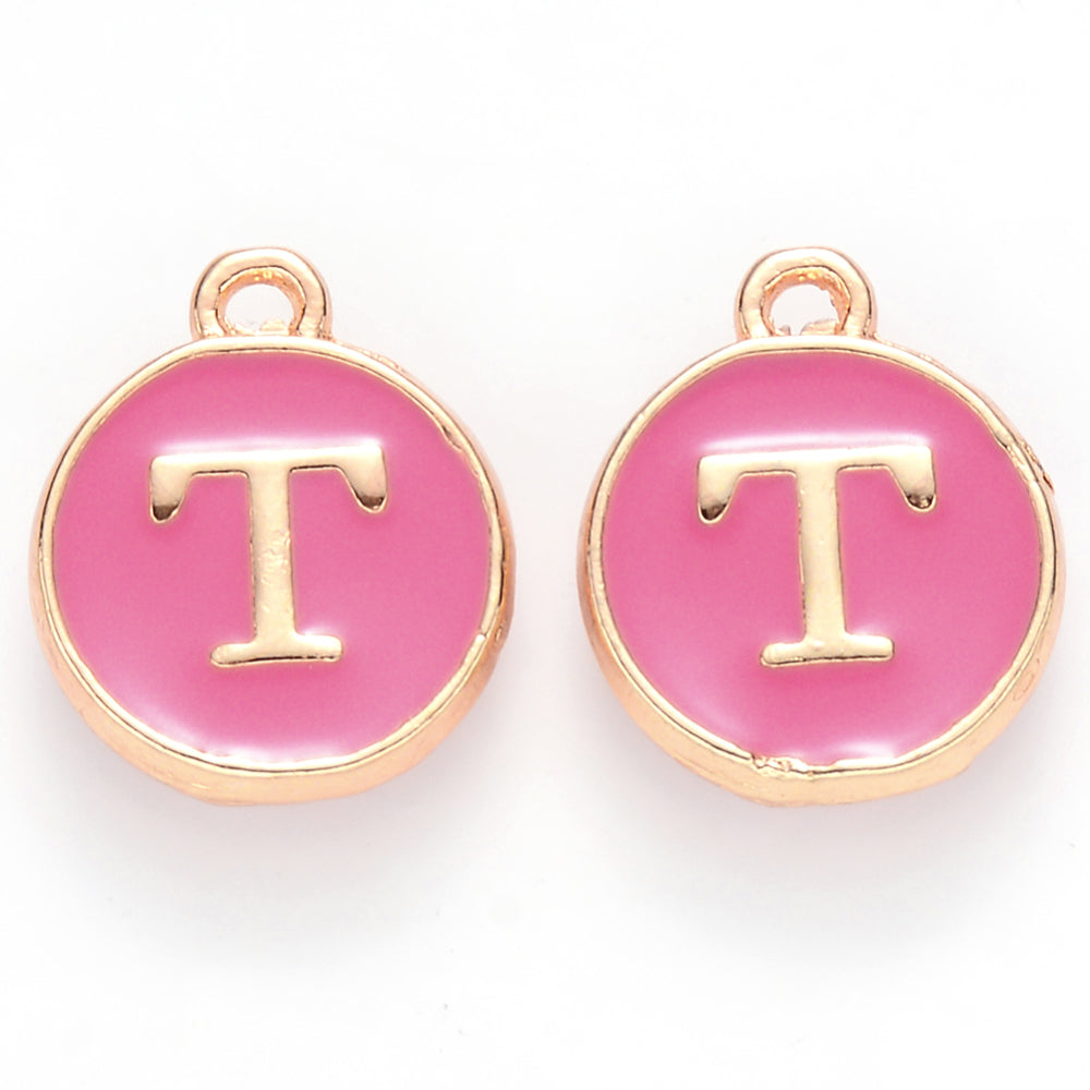 Round enamel charm with gold-tone border, letter T on pink face, hanging loop