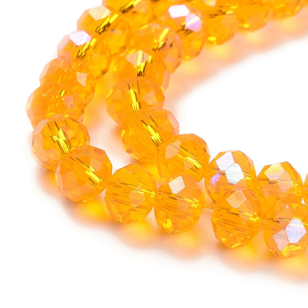 Faceted glass rondelle beads close-up, golden-orange with reflective iridescent facets