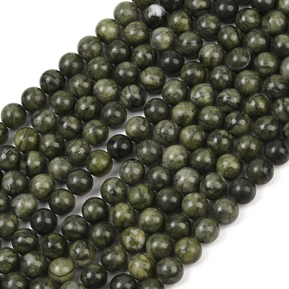 Round olive green jade beads strand, close-up view of dark and light mottling