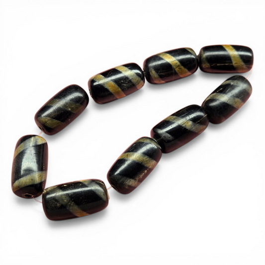 Tube beads with black base and gold spiral stripes