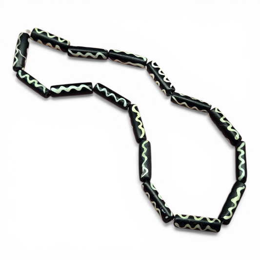 Black tube bead strand with off-white wavy line stripe motif, vintage style