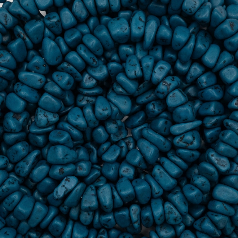 Teal chip resin beads, close-up with speckled texture and irregular shapes