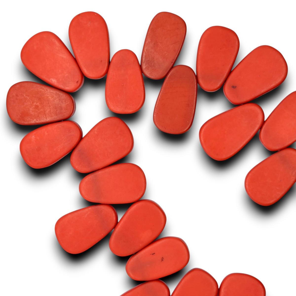 Red flat teardrop resin beads strand with smooth, rounded teardrop shapes